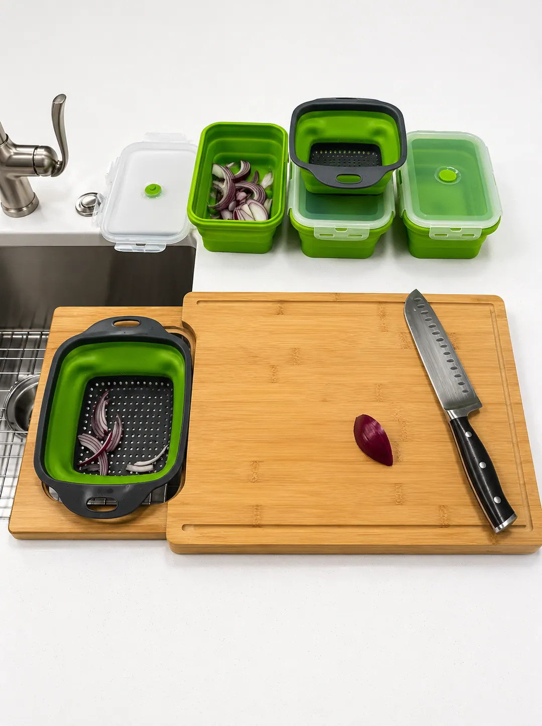 Collapsible colander holding sliced onions beside the bamboo cutting surface
