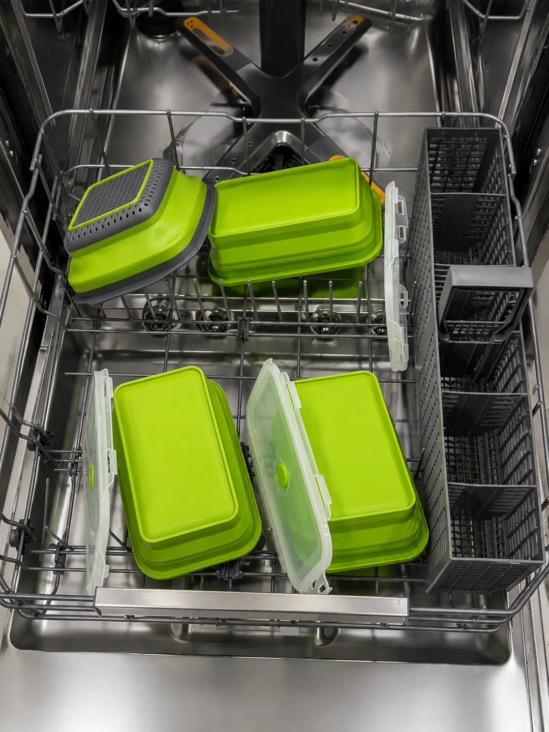 Green collapsible containers and strainer components loaded in a dishwasher