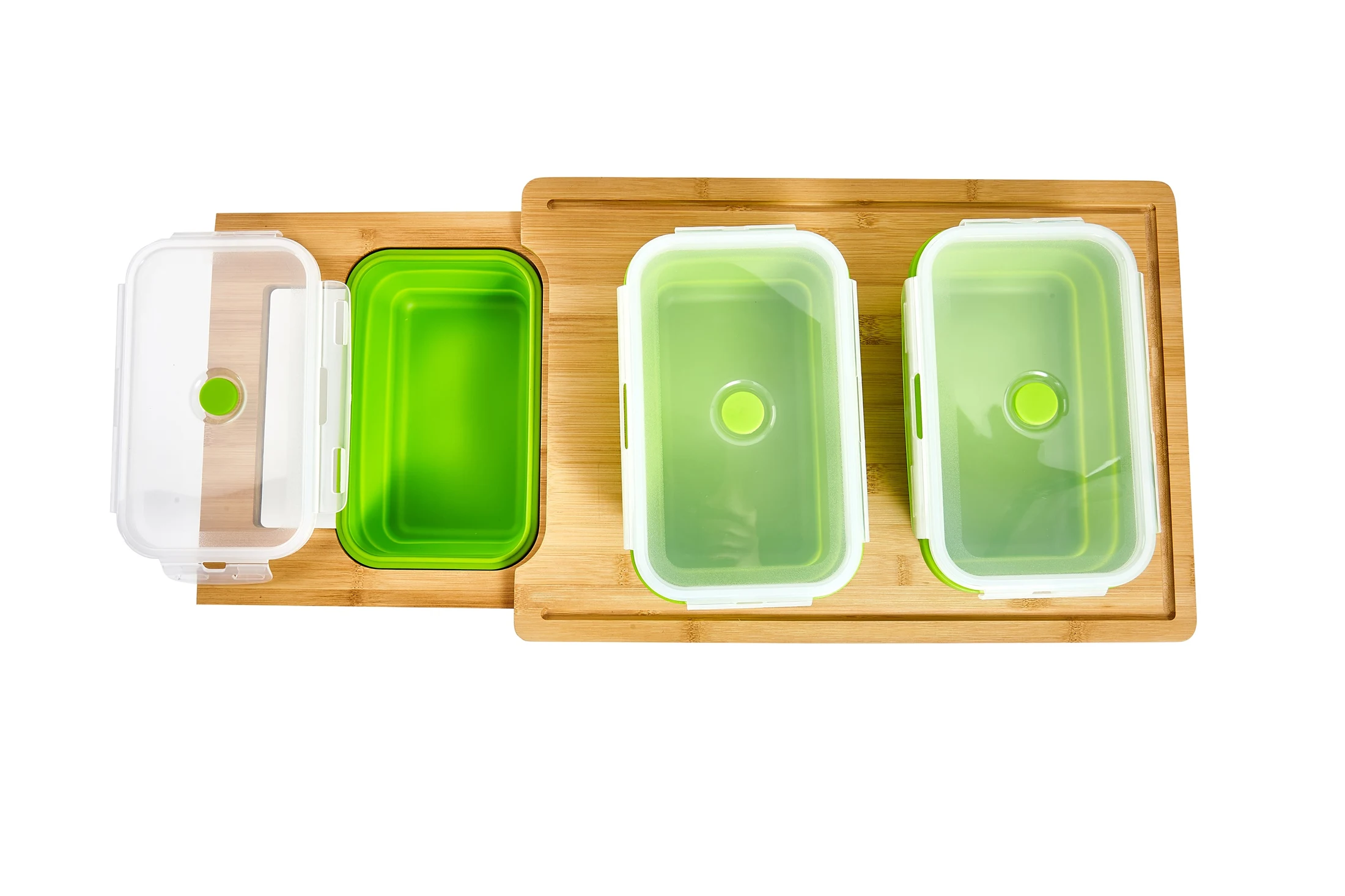 Three green collapsible containers seated in the bamboo meal prep board